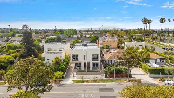an aerial view of residential houses with city view
