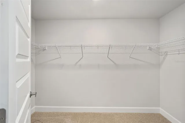 a bathroom with a granite countertop sink a toilet a mirror and shower