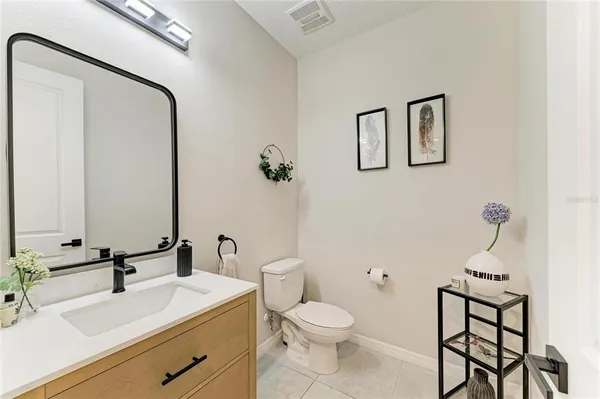 a bathroom with a sink toilet and mirror