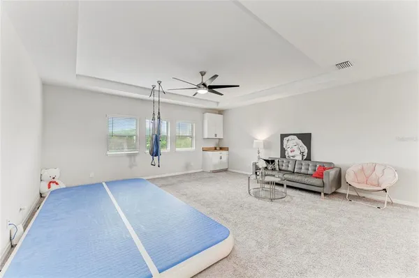 a bedroom with a large bed and a chandelier