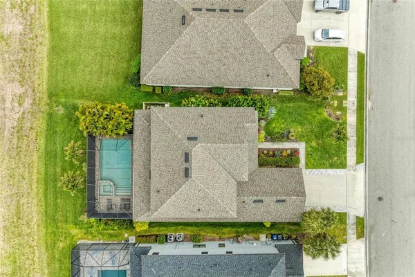 a view of a house with a small yard and flower plants