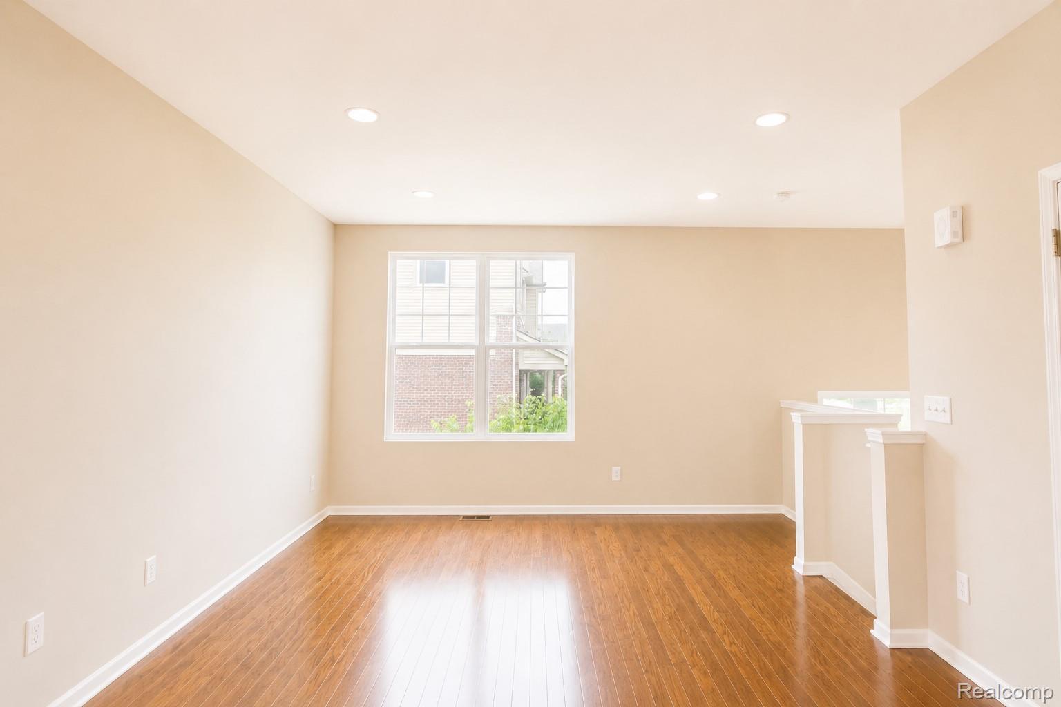 2940 Glenbar Circle Rochester, MI 48307 - Photo 7 of 15 Spacious room featuring wood-finish flooring, light-colored walls, recessed lighting, and a multi-pane window