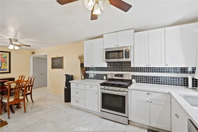 a kitchen with cabinets stainless steel appliances and a counter space