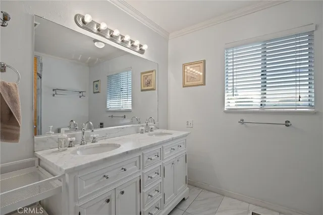 a bathroom with a sink double vanity and a mirror