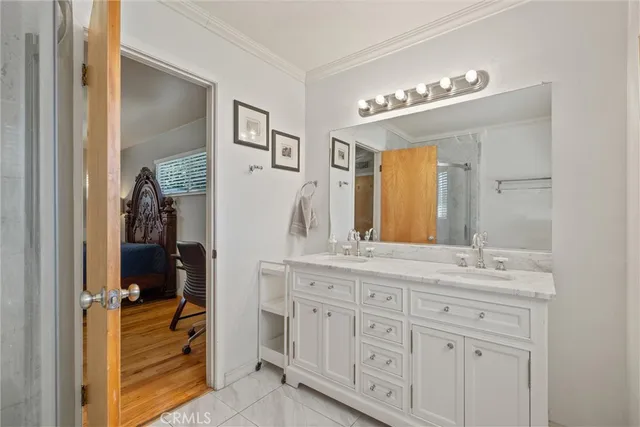 a bathroom with a double vanity sink and a mirror
