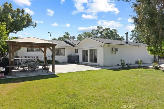 a view of a house with pool and chairs