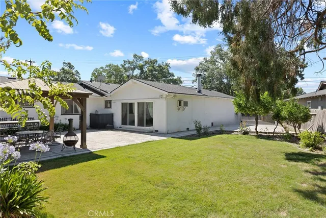 a swimming pool with outdoor seating and yard