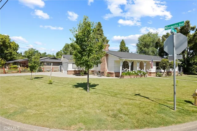 a house view with swimming pool and trees in the background
