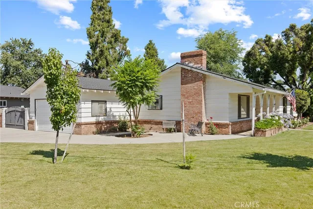 a house view with swimming pool and garden space