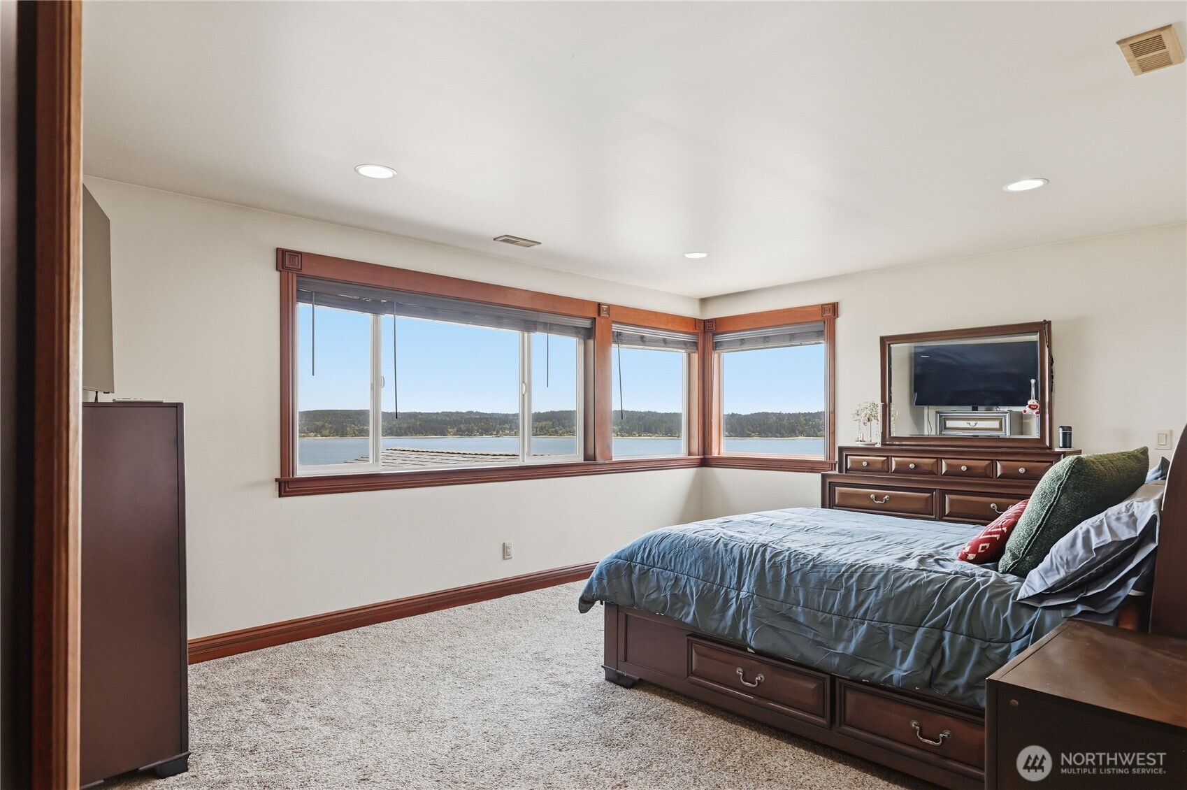1411 Thorndyke Road Port Ludlow, WA 98365 - Photo 29 of 40 a bedroom with a bed and a flat screen tv