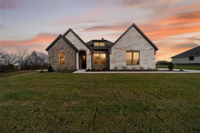 a front view of house with yard and green space