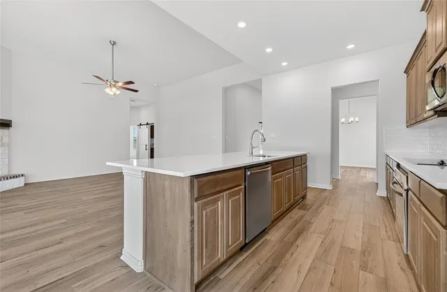 a kitchen with a sink and wooden floor