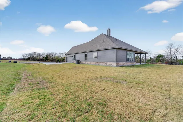 a view of a house with yard and ocean view
