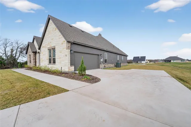 a front view of house with yard and lake view