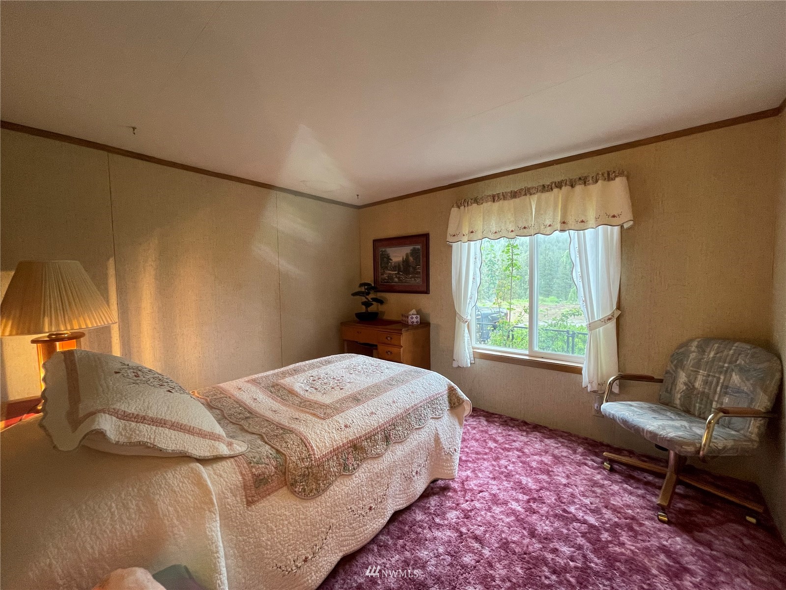 103 Klondike Road Republic, WA 99166 - Photo 18 of 38 a bedroom with a bed and a chair