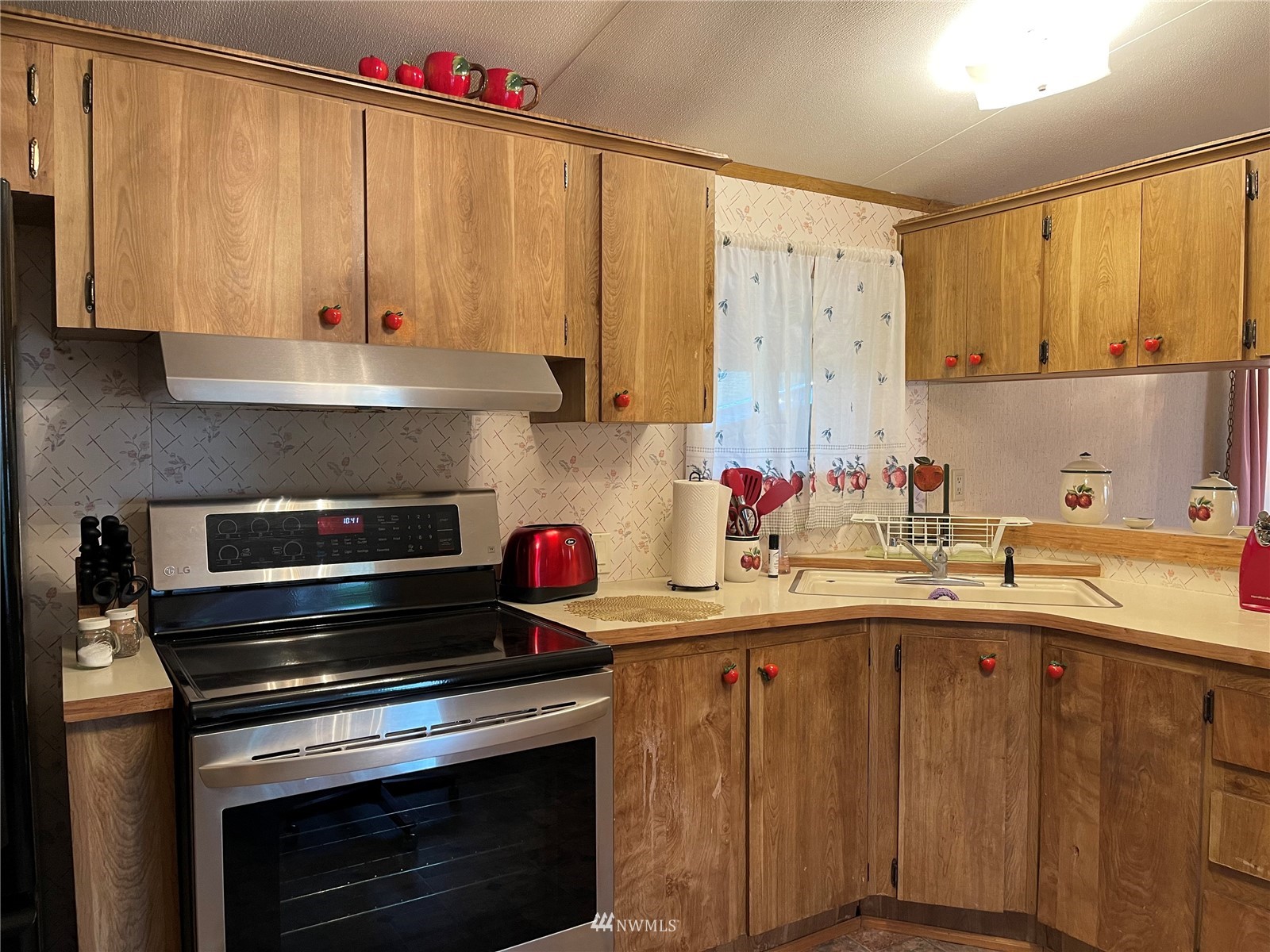 103 Klondike Road Republic, WA 99166 - Photo 3 of 38 a kitchen with a sink stove and cabinets