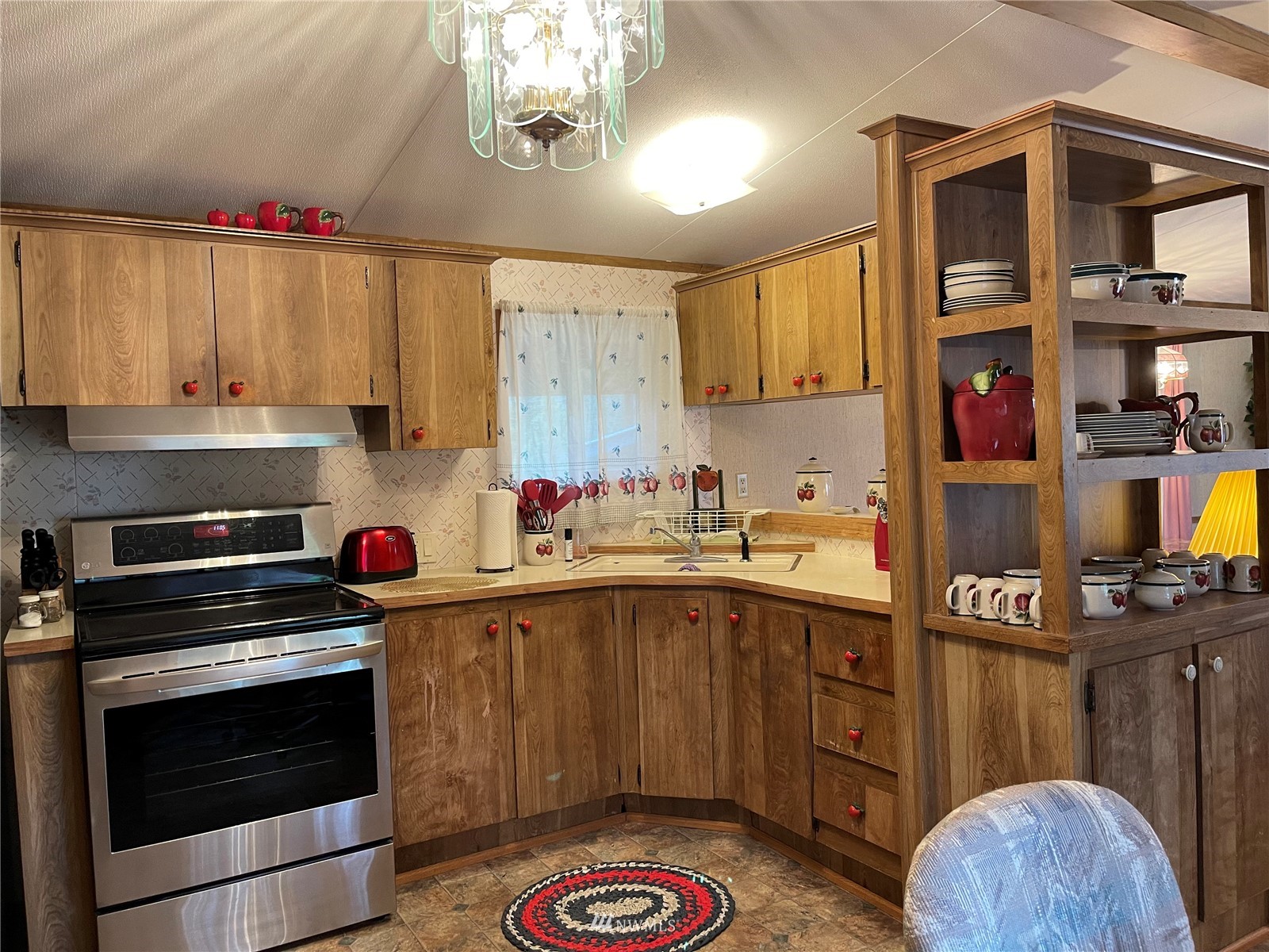 103 Klondike Road Republic, WA 99166 - Photo 6 of 38 a kitchen with stainless steel appliances a stove a sink dishwasher and cabinets with wooden floor