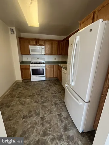 a kitchen with a refrigerator and a stove