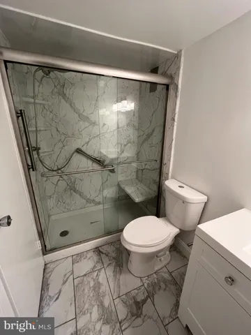 a bathroom with a toilet and a shower