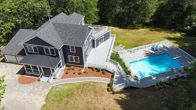 an aerial view of a house with yard swimming pool and outdoor seating
