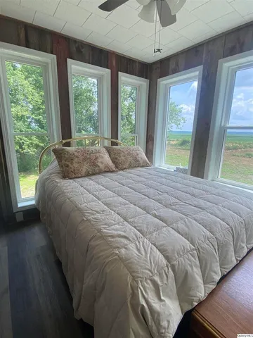 a large bed sitting in a bedroom next to a large window