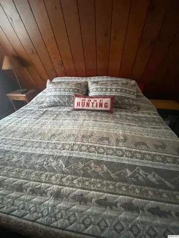 a bedroom with a bed and window