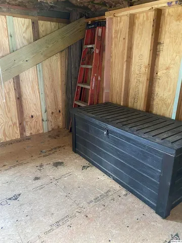 a view of a room with wooden walls and stairs