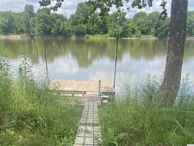 a front view of a house with a yard and a garage