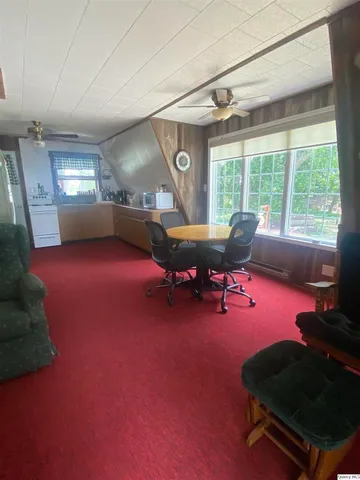 a living room with furniture and a pool table