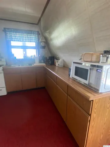 a kitchen with stainless steel appliances granite countertop a sink and a microwave