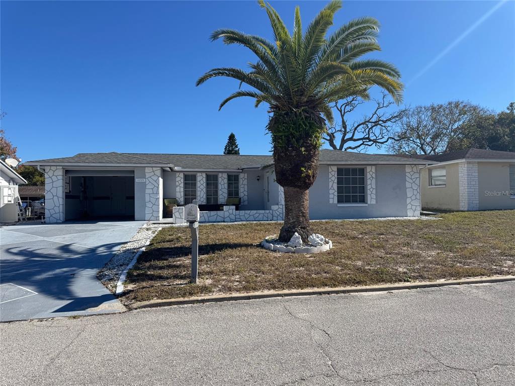 11234 Linden Lane Port Richey, FL 34668 - Photo 1 of 25 a front view of a house with porch