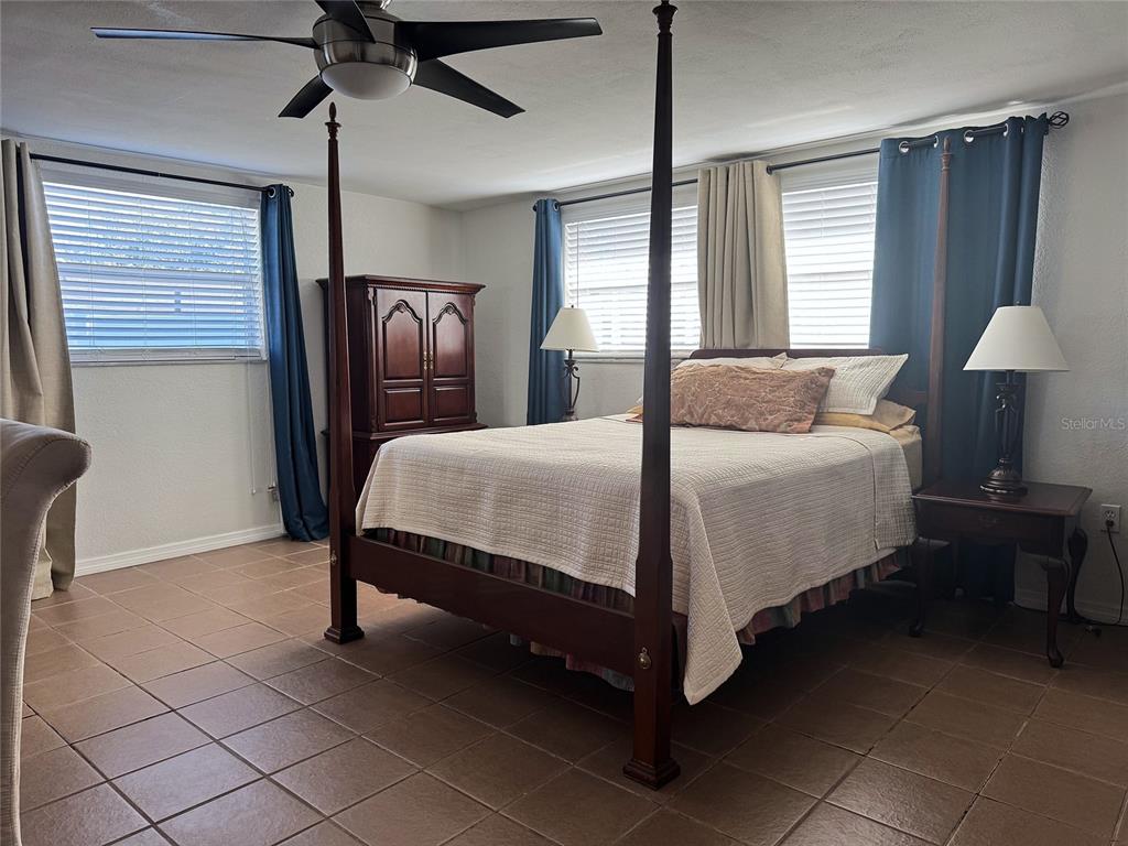 11234 Linden Lane Port Richey, FL 34668 - Photo 12 of 25 a bedroom with a bed and a lamp