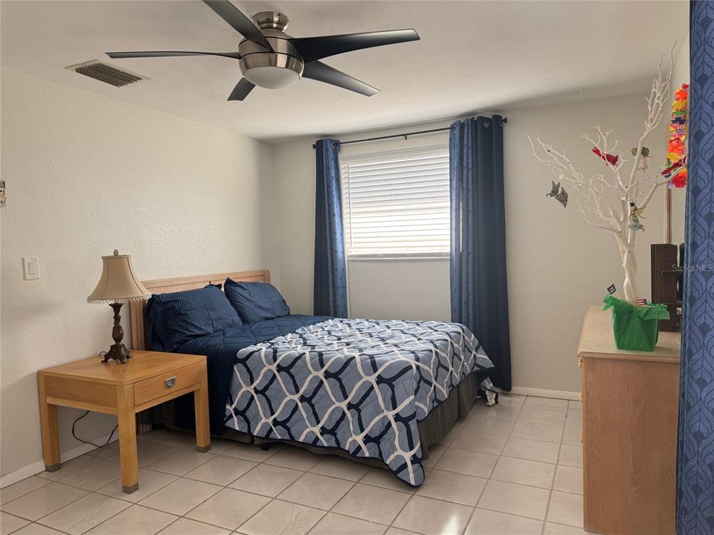 11234 Linden Lane Port Richey, FL 34668 - Photo 19 of 25 a bedroom with a bed and a table