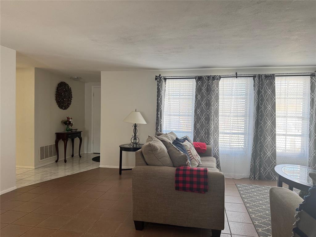 11234 Linden Lane Port Richey, FL 34668 - Photo 2 of 25 a living room with furniture and a large window