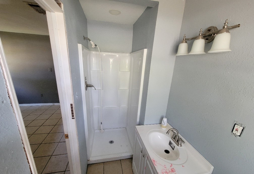 705 Inwood Drive Baytown, TX 77521 - Photo 11 of 15 a bathroom with a sink and shower
