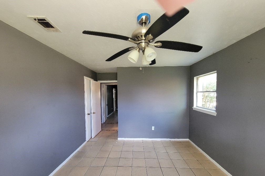 705 Inwood Drive Baytown, TX 77521 - Photo 12 of 15 a view of an empty room with a window