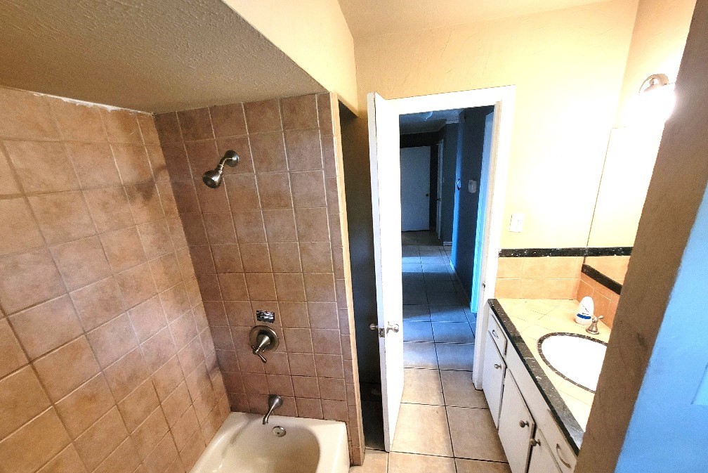 705 Inwood Drive Baytown, TX 77521 - Photo 14 of 15 a bathroom with a tub and a shower