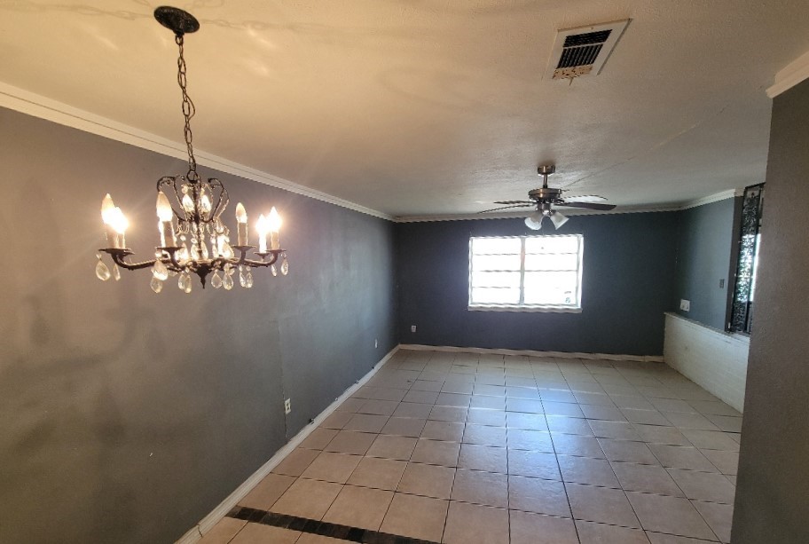 705 Inwood Drive Baytown, TX 77521 - Photo 6 of 15 a view of a room with a chandelier fan and windows