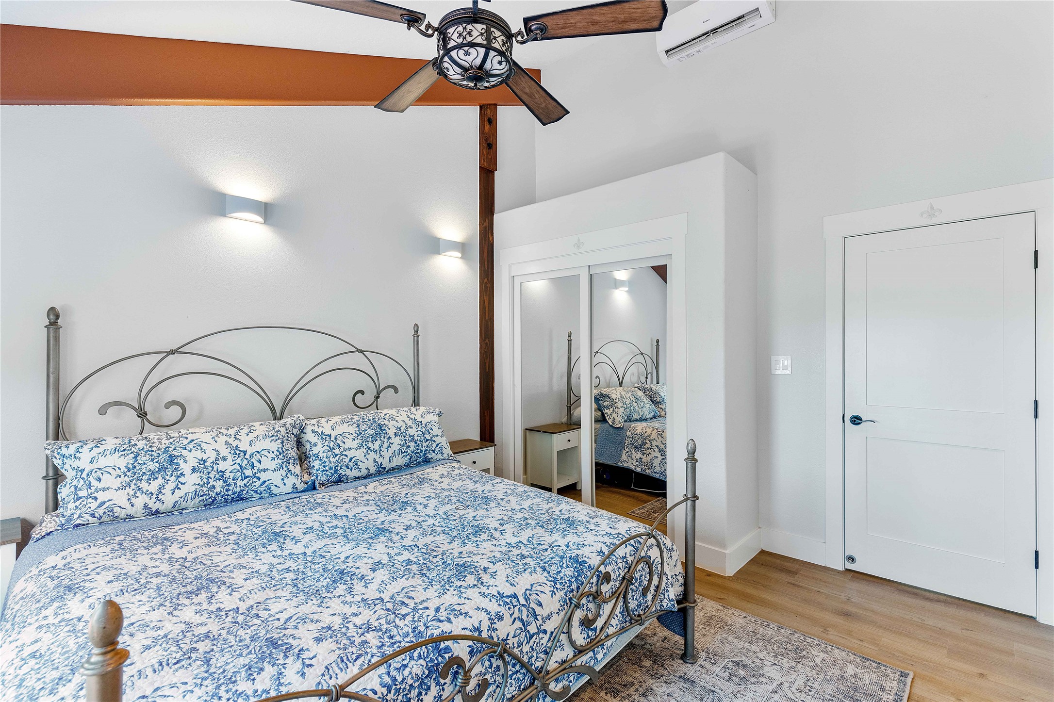 6641 Eagle Road Anahuac, TX 77514 - Photo 42 of 50 a bedroom with a bed a lamp and a walk in closet with wooden floor