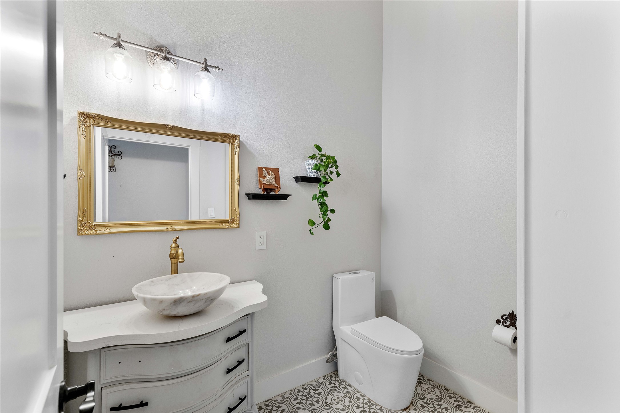 6641 Eagle Road Anahuac, TX 77514 - Photo 43 of 50 a bathroom with a toilet sink and mirror