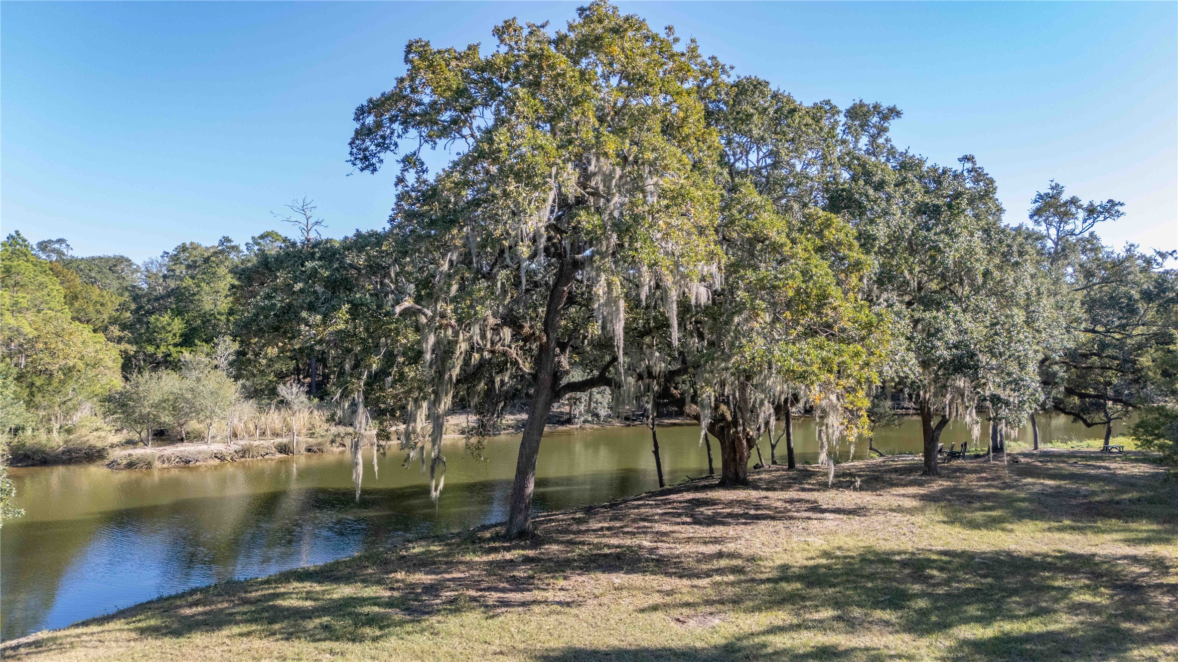 6641 Eagle Road Anahuac, TX 77514 - Photo 8 of 50 a view of a lake with a building in the background