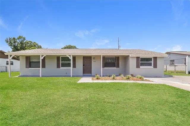 a front view of a house with a garden and patio
