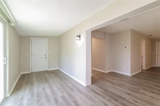 an empty room with wooden floor