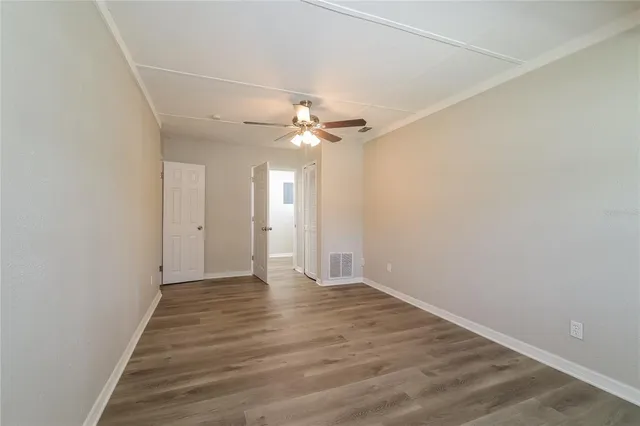 a view of an empty room with a ceiling fan