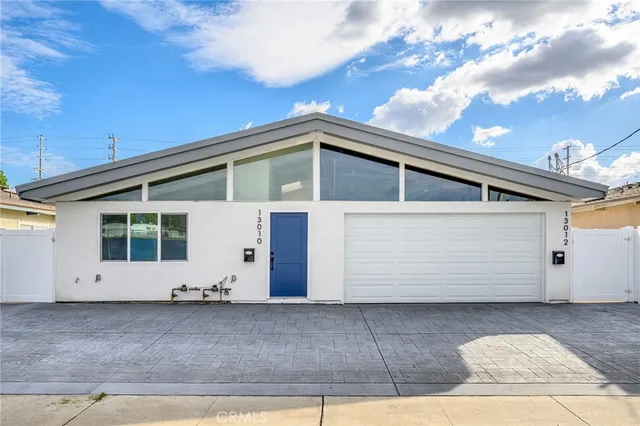 a view of a white house with a large window