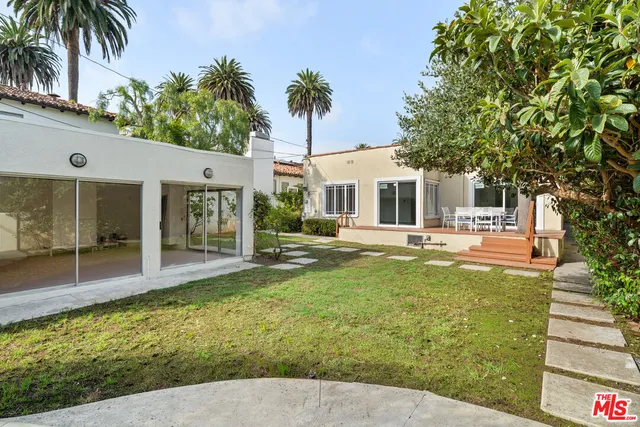 a view of a house with a backyard porch and sitting area