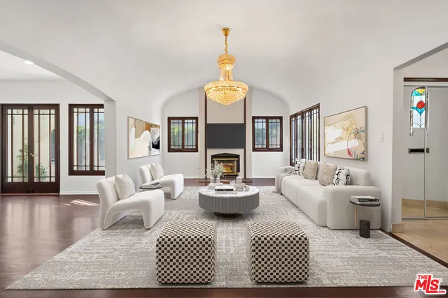 a living room with fireplace furniture and a wooden floor