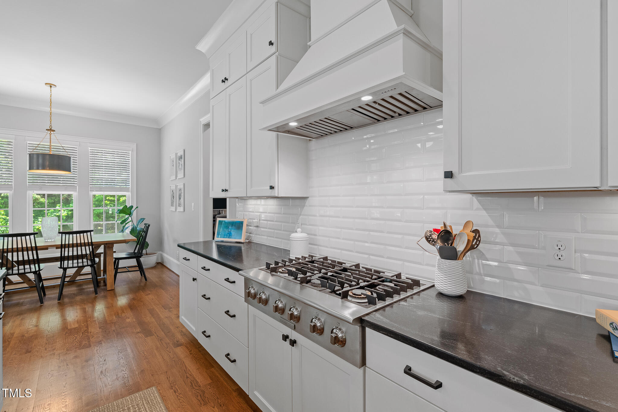 2993 Club Drive Raleigh, NC 27613 - Photo 23 of 94 a kitchen with stainless steel appliances granite countertop a stove and a refrigerator