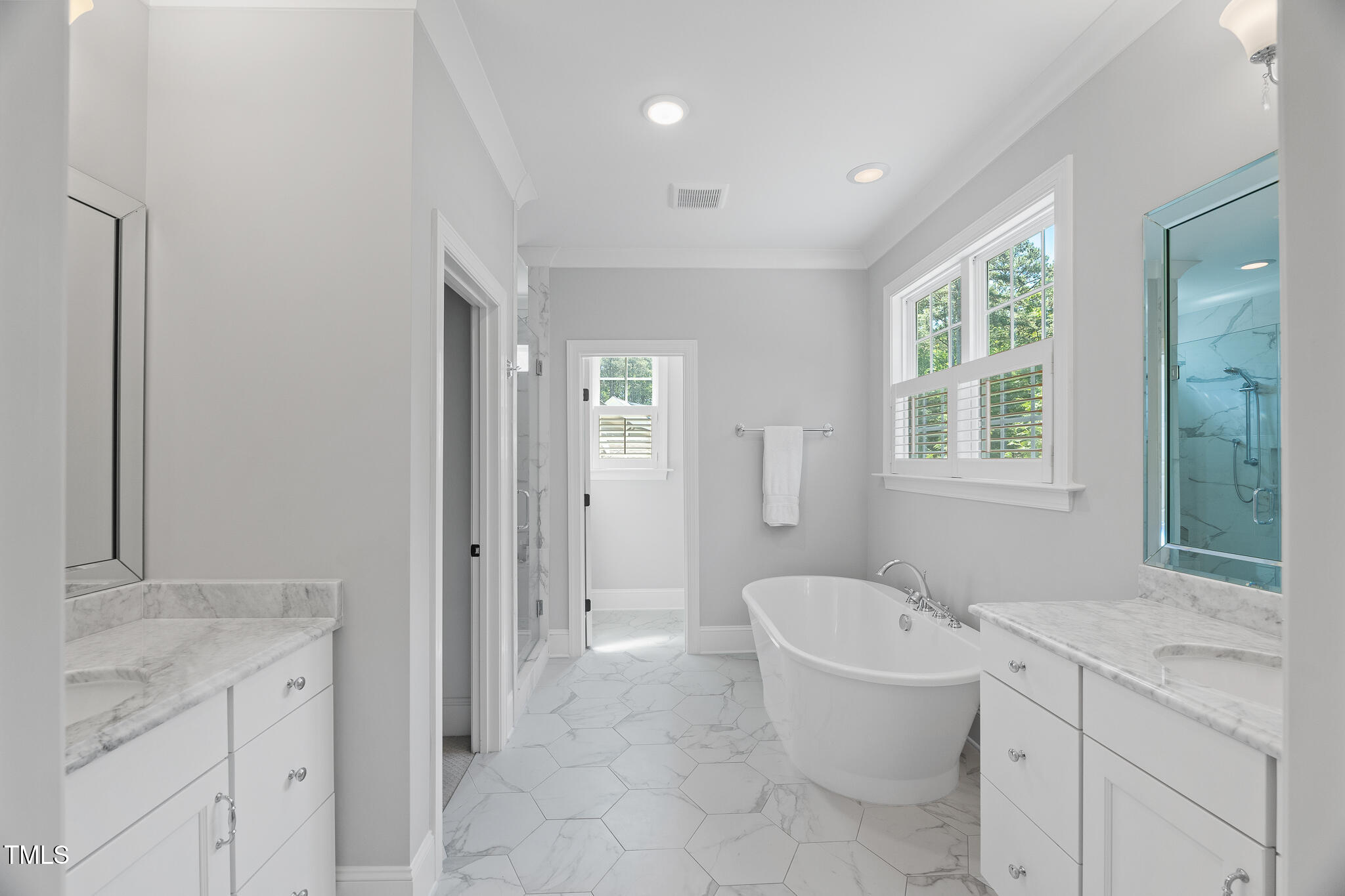 2993 Club Drive Raleigh, NC 27613 - Photo 50 of 94 a spacious bathroom with a granite countertop sink a toilet a mirror and a bathtub