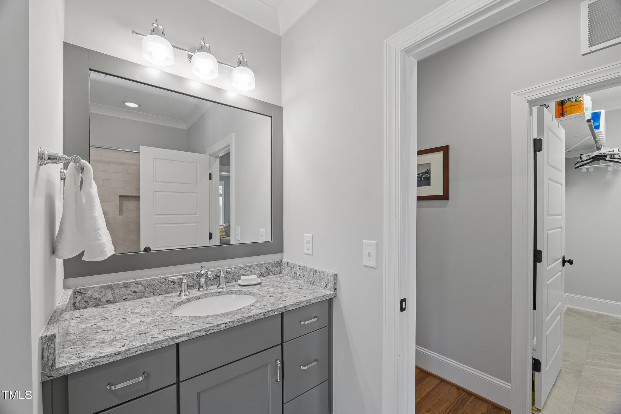 2993 Club Drive Raleigh, NC 27613 - Photo 57 of 94 a bathroom with a granite countertop sink and a mirror